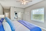 Master bedroom with a king bed, flat screen TV and beautiful nature preserve views